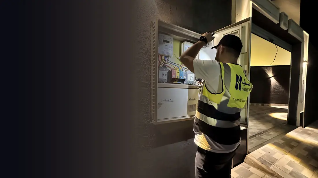 A Hulul technician inspecting an electrical panel